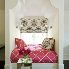 Authentic guest bedroom reading nook with pink, black, and white textiles