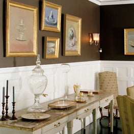 Dining room with dark walls and art gallery