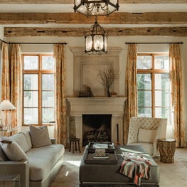 Muted Perfection / Hand hewn beams from Europe give structure to this cozy family room filled with light and simple, elegant Italian furnishings.