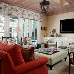 The garden room features  floral fabrics on the chairs and  the valance.