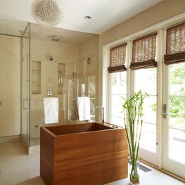 Luxurious bathroom in Scarsdale, NY with wood soaking tub and glamorous lighting