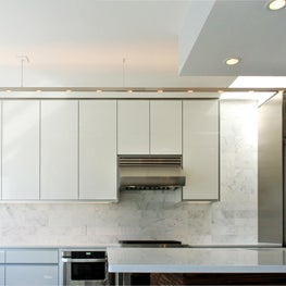 Modern White Kitchen with Custom Cabinetry & Linear Lighting