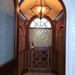 Costal Residence Wine Cellar with Art Glass Window