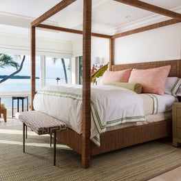 In the master bedroom a four-poster bed wrapped in natural rope feels organic.