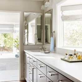 Cloud White Master Bathroom with Walnut Vanity Cabinets