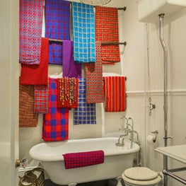 For a pop of color, a display of traditional Maasai cloths in a bathroom