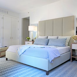 West Village Triplex Master Bedroom with light colors, double mirrors, chair