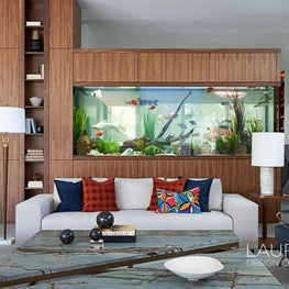 These grand fish tanks act as a partition between the communal space and more secluded library.