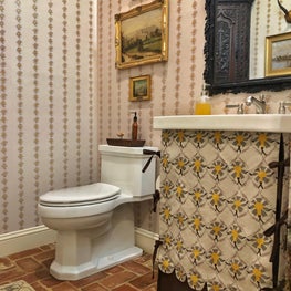 English Antiques and Mally Skok fabric complete this southern traditional powder room.
