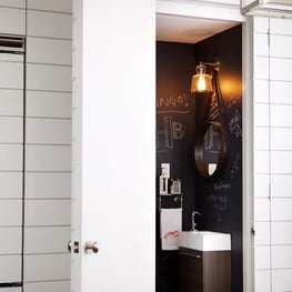Matte black chalk board powder room with industrial accents