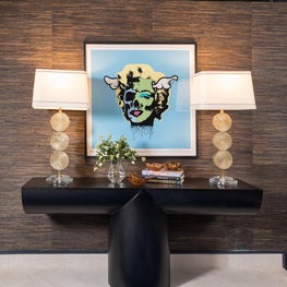 Penthouse foyer featuring vintage lamps and modern art