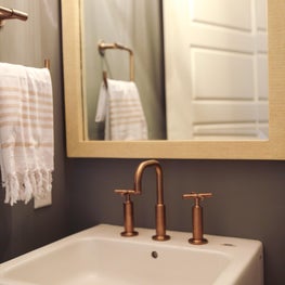 A copper design aesthetic in powder room