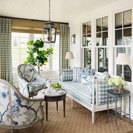 Contemporary farmhouse dining porch with floral and gingham seating