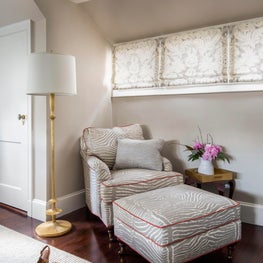 Grey & red linen zebra arm chair & ottoman, brass floor lamp, roman shades