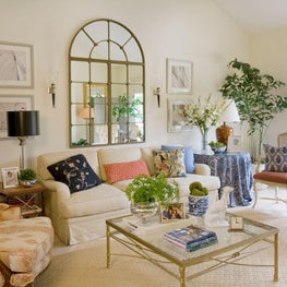 Transitional living room with soft palette and focal mirror