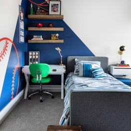 Portfolio: A boys bedroom with blue walls and athletic patterns