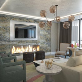 Modern, yet cozy upholstered furniture in soft neutral tones and a warm hearth..