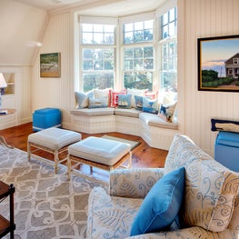 Subtle floral fabrics complement the trellis patterned area rug.