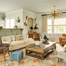 Family room with an mix of antiques, custom furniture, and rich textures 