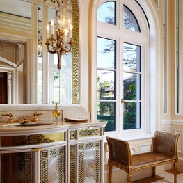 Custom eglomise mirror and vanity details on 4-part limestone floor pattern