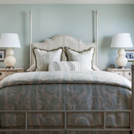 This bedroom has a calm and soothing blue color scheme with ivory furnishings.