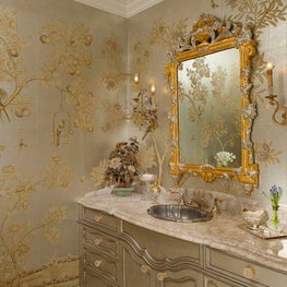 Of particular note is thispowder room which is adorned with hand painted Chinese scenic wallpaper, a custom vanity decked in white quartz, an antique mirror, and mirrored sconces designed to echo the room’s bird motif