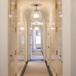 Park Avenue apartment, Hallway with white lacquered walls and globe pendants