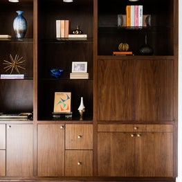 Portfolio: Dark wood bookshelf in a mid-century modern study room