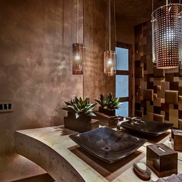 Repeating richer, more elegant color tones give the powder room a polished look