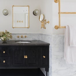 Master Bathroom with Brass Towel Warmer and Marble Accents