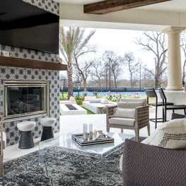 Portfolio: Exterior living space with tiled fireplace and spacious seating in Houston, Texas