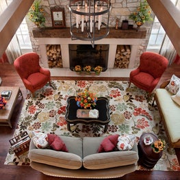 American Lodge Family Room. Catwalk view. Stone fireplace with built-in wood storage, coral accents & vaulted ceilings.