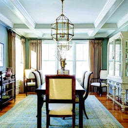  Coffered ceiling, wainscoting, and pair of oversized lanterns over the table