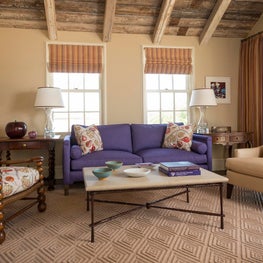 Adorable and colorful cottage living room with exposed wood beams