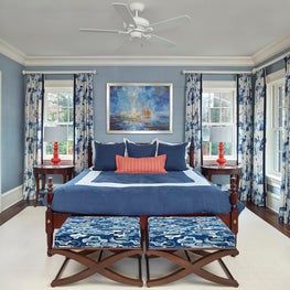 Blue Guest Bedroom with Contrasting Orange Lamps