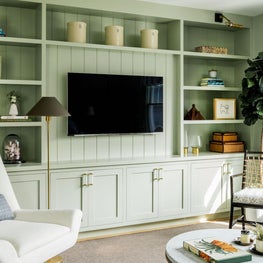 Tradition study with green painted built-ins and modern furniture