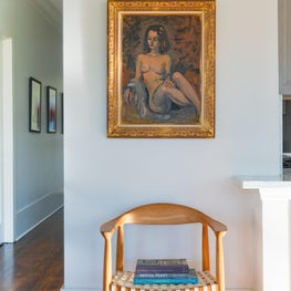 Vignette shot of vintage chair and original artwork