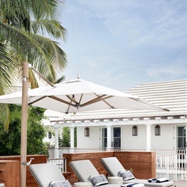 Outdoor Seating, Restoration Hardware Teak Mesa Chaises, Tuuci Ocean Master Umbrella, Made Goods Dennison Stools
