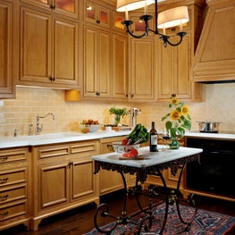 Wooden cabinets add warmth and color to this transitional kitchen.
