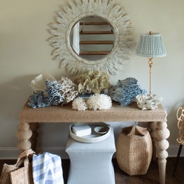 Layers of rattan and wicker give this beach house entryway a sense of nostalgia