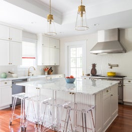All white kitchen with custom cabinetry and geometric ceramic backsplash