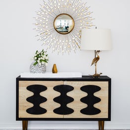 Upper East Side Entry with console starburst mirror, bird lamp and accessories
