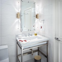 A sleek white powder room is always perfect.