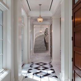 Mixed marbles and crisp white Colonial Georgian detailing in a gallery