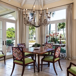 Ocean view dining, an antique chandelier all surrounded by patterned deco chairs