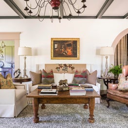 Living room anchored with a high back sofa and warm palette