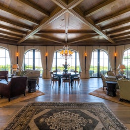 Great Room with Arched Steel French Doors and Walnut Ceiling Beams
