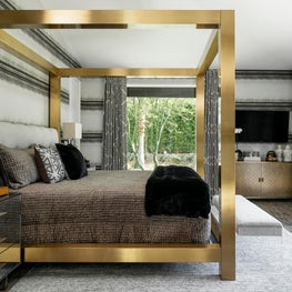 Modern gray and white bedroom with brass bed