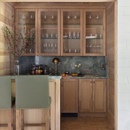 From the penny gap planking to the French curve detail at the faucet, there is no shortage of architectural charm in this home bar.