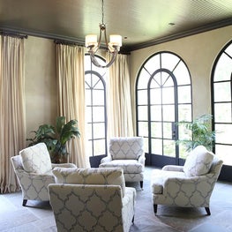 Sunroom with arched steel windows.  